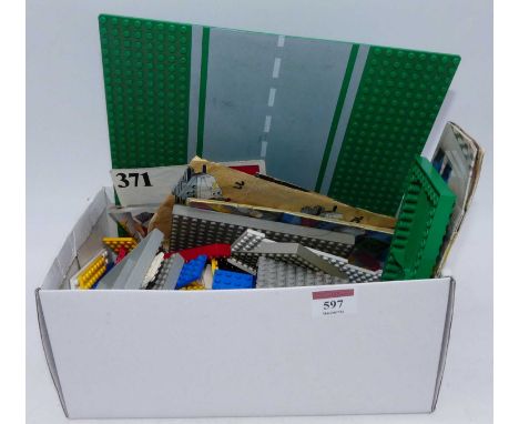 A collection of vintage Lego pieces and manuals 