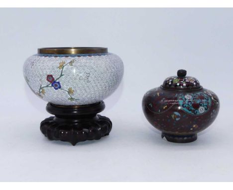 A Japanese cloisonne bowl, of squat circular form, enamel decorated with flowers and on a pierced hardwood stand, dia.14cm; t