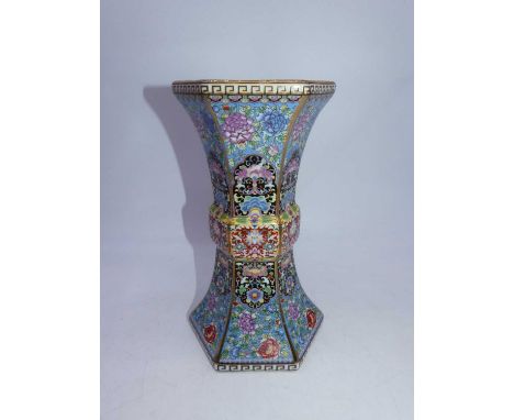 A reproduction Chinese vase, of hexagonal gu shape, enamel decorated with flowers on a blue ground within Greek Key borders, 