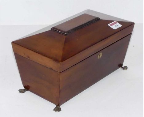 An early Victorian mahogany tea caddy, of sarcophagus form, the hinged lid opening to reveal twin compartment interior, with 