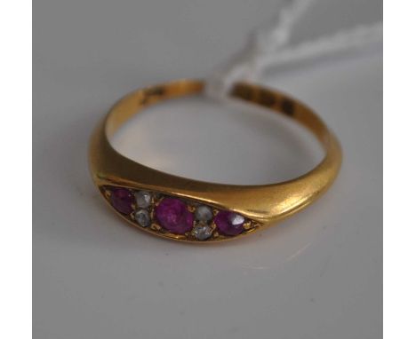 A vintage 18ct gold ruby &amp; diamond ring, arranged as three graduated round cut rubies, each dispersed with two small rose