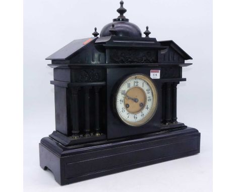 A large late Victorian black slate mantel clock, of architectural form, having an enamelled chapter ring with Arabic numerals