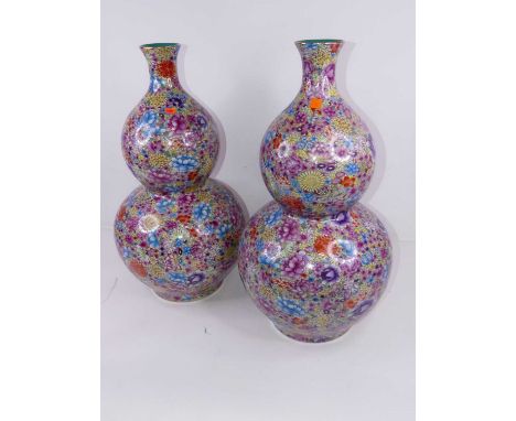 A pair of large reproduction double-gourd vases, enamel decorated with flowers in shades of pink, yellow and blue, h.66cm