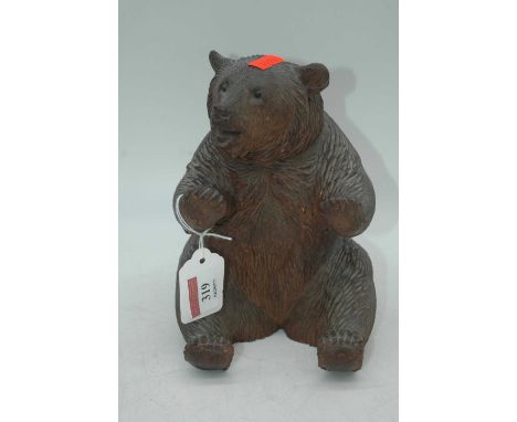 An early 20th century Black Forest carved wooden model of a bear, 19cm high