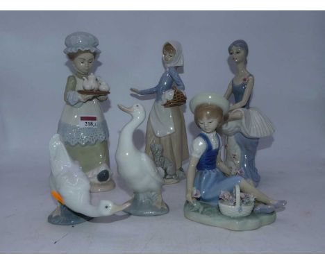 A Lladro Spanish porcelain figure of a young girl, in seated pose with basket of flowers at her feet, having printed mark ver