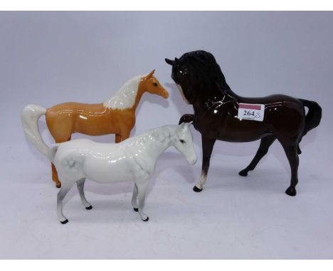 A Beswick model of a stocky jogging mare, model No. 1090, brown gloss finish, together with a Royal Doulton Palomino pony, br