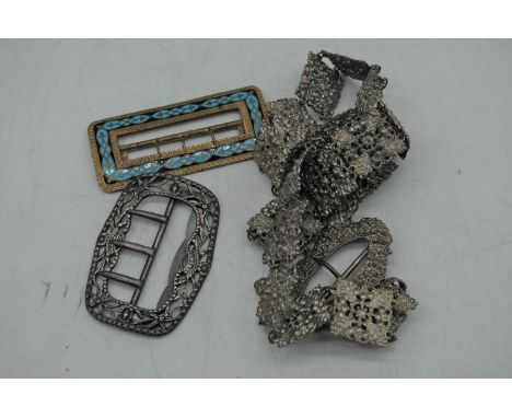 A silver belt buckle, marks rubbed, 1.3oz, together with an enamel decorated brass belt buckle, and a silver plated nurse's b
