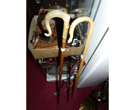 A collection of vintage walking sticks; together with a shooting stick and golf club 