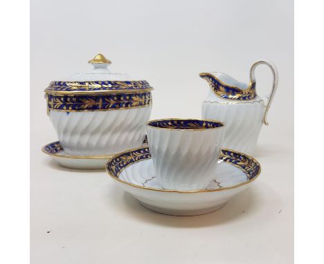 A Worcester porcelain part tea service, with blue band, highlighted in gilt, comprising eleven cups, nine saucers, cream jug,