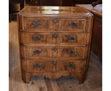 A 1920's walnut dressing chest, the top drawer fitted with mirror and various compartments, above three drawers, on bracket f