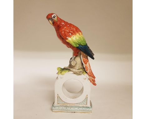 A 19th century Vienna style clock case, with parrot finial, beehive mark to base, 29 cm high, a Dresden mirror with figural m