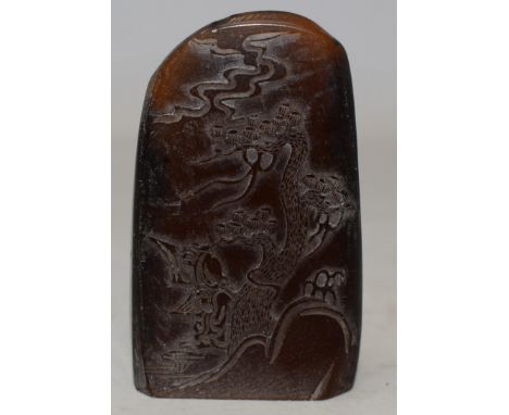 A Chinese hardstone carved pebble, decorated with two figures below a knarled tree, height 8 cm 