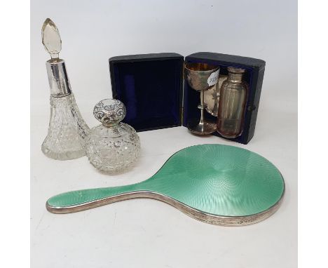 A Victorian small silver travelling communion set, cased, a silver and enamel hand mirror, and two silver mounted scent bottl