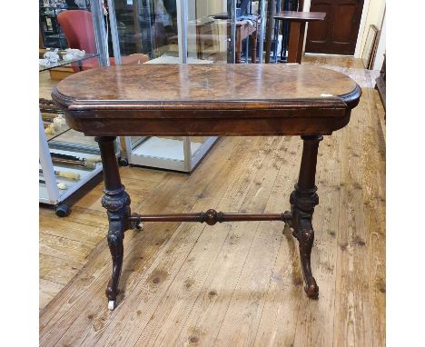 A 19th century walnut card table, on column supports, united by a stretcher, on carved splayed legs, 93 cm wide 