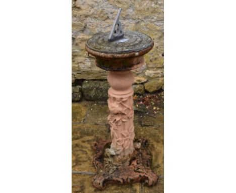 A terracotta coloured composite stone pedestal, with lead sundial, 74 cm high 