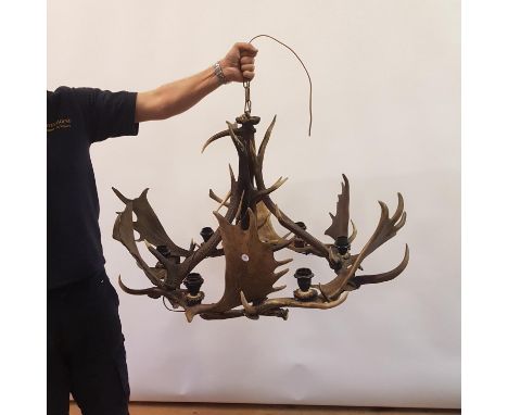 A chandelier, constructed from antlers, 94 cm diameter, and a matching wall light 