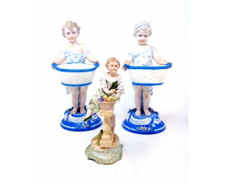 A pair of early 20th century Dresden figures, of a young boy and girl holding baskets, 22 cm high, a Continental figure of a 