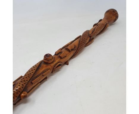 A 19th century one piece folk art walking stick, staff carved with animals, implements, and sporting items, 91 cm 