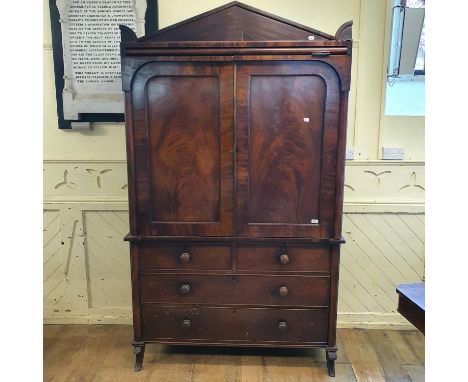 A 19th century mahogany linen press, the architectural pediment above a pair of panel doors, the base with two short and two 