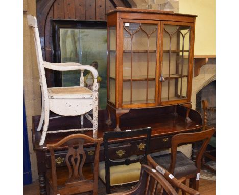 A 19th century stained pine table, with a three quarter back and frieze drawers, an oak display cabinet, and a painted commod