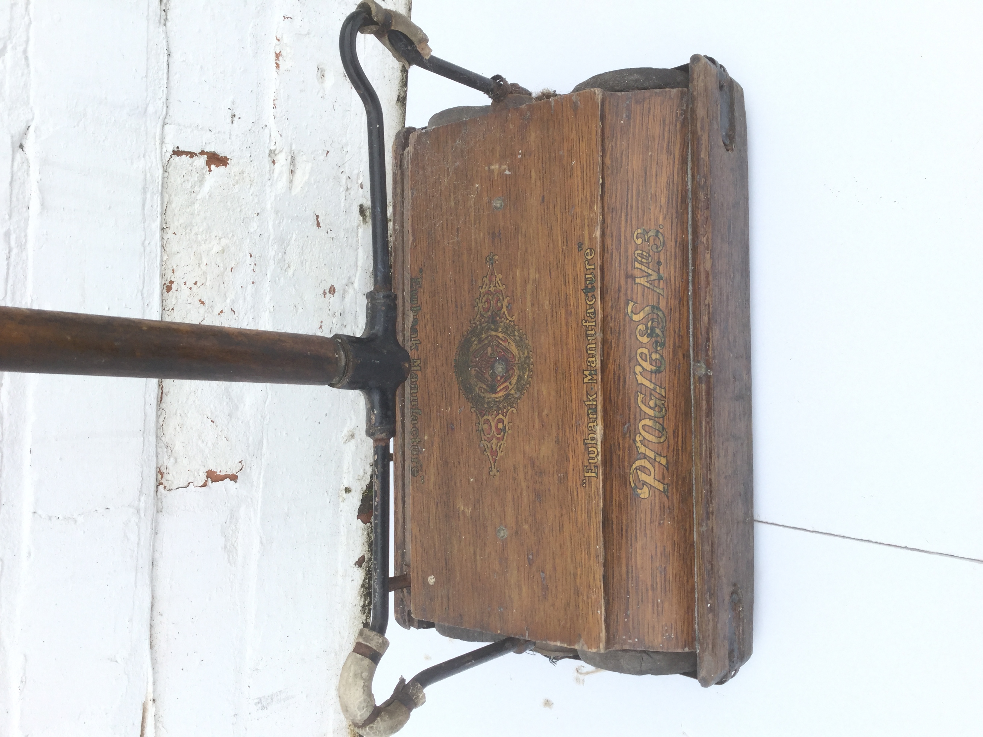 Two Ewbank vintage carpet sweepers, the wood boxes on rollers with long