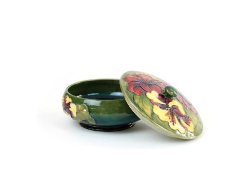 Moorcroft "Hibiscus" Pot with Cover Tubeline decorated against green ground, impressed marks to base.14.5cm diameterCrazing t