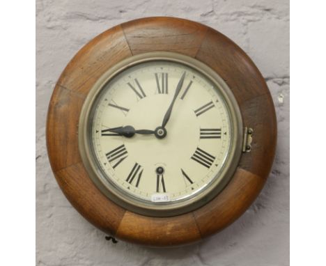 A mahogany cased station clock with white enamel dial and Roman numeral markers (with key).