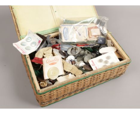 A basketware sewing box and contents of vintage buttons.