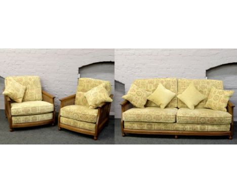 An Ercol bergere three piece suite, consisting of two seat sofa and his and hers arm chairs.Condition report intended as a gu