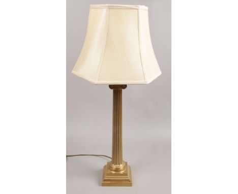 A large brass effect column table lamp.