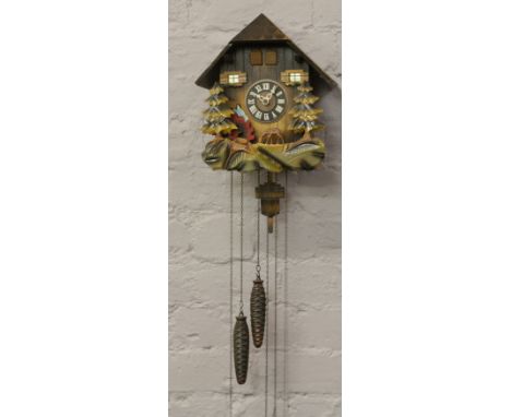 A West German musical cuckoo clock with pendulum and weights.