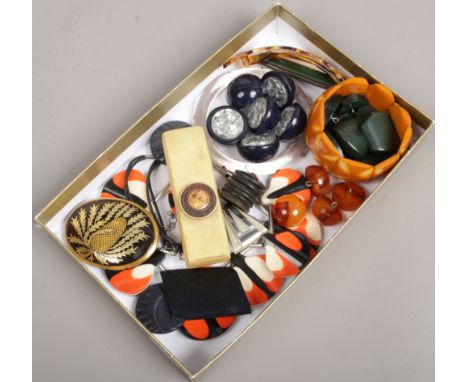 A tray of vintage celluloid and Bakelite buttons and jewellery.