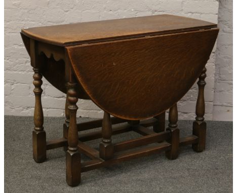 An oak gate leg dining table.