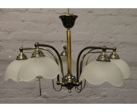 A pair of chrome and brass five branch ceiling lights with frosted glass shades and a similar dining room light.