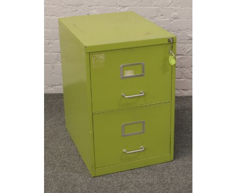 A vintage olive green steel two drawer filing cabinet, keys in office.