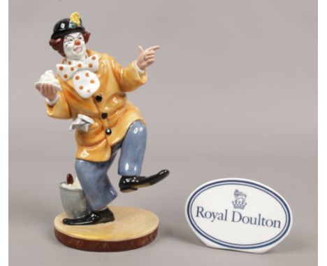 A Royal Doulton figure The Clown HN2890, along with a Royal Doulton ceramic sign.