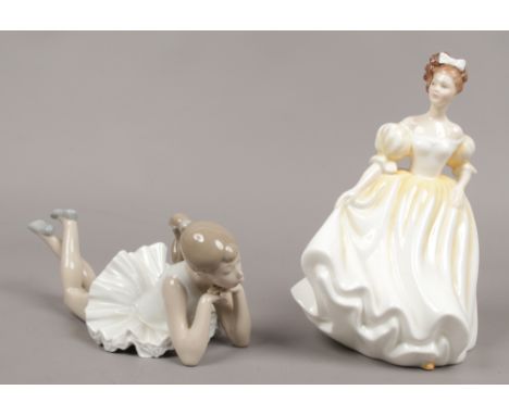 Two ceramic figurines to include a Nao example of a laying girl along with a Royal Doulton lady titled Natalie HN3173.