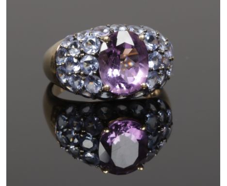 A 9ct gold dress ring set a pave of amethyst and an iolite of bombe form, size N.