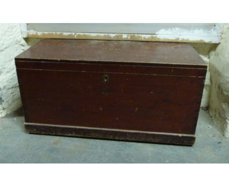A late 19thC stained pine trunk with candle box, H56 x W115 x D46cm