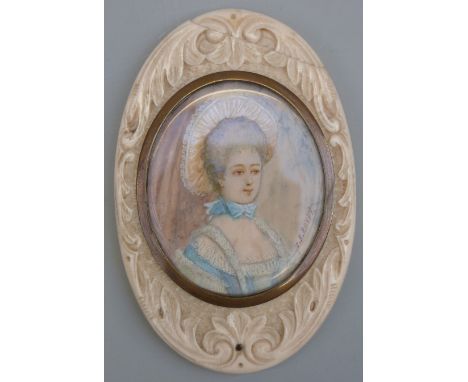 A 19thC portrait miniature on ivory, head and shoulders bust of a lady in fine attire, signed J B Royby, in carved oval ivory