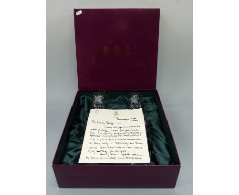 A boxed set of four Asprey & Garrard wine glasses, with facsimile letter from Prince Charles 'To all staff', the glasses deco