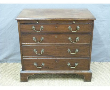 A Georgian mahogany bachelor's chest of four graduated drawers with brushing slide, raised on bracket feet, H78 x W83 x D47cm