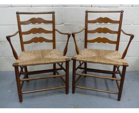 A pair of Cotswold School/Macclesfield rush seated ladder back Arts and Crafts armchairs