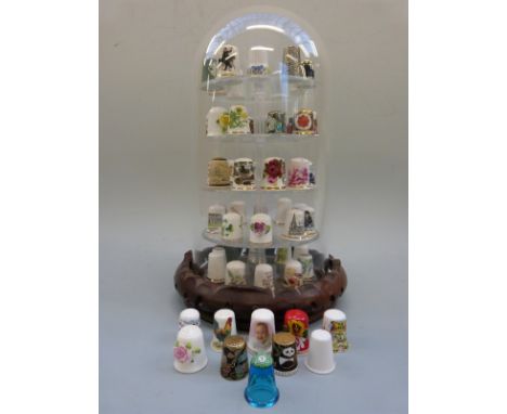 A collection of thimbles on a stand including Spode, Caverswall etc