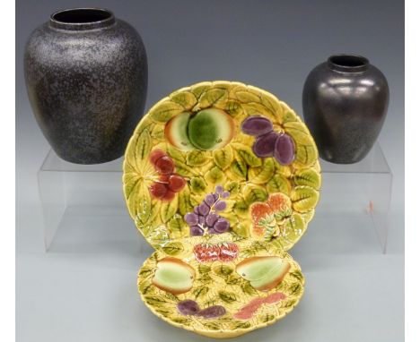 Two Poole Pottery vases and two majolica plates by Sarreguemines