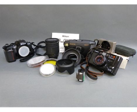 A quantity of cameras to include Nikon F-601 SLR, Tamron 28-200mm 1:3.8-5.6 lens, Polaroid, Canon etc