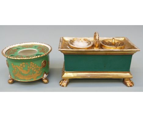 Two 19thC porcelain inkwells, both with green ground and raised on lion's paw feet, one with raised gilt decoration of birds 