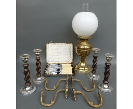 An oil lamp with glass shade together with four candle sticks of barley twist design, four metal curtain holders and a six pl