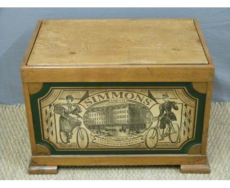 A wooden storage box or toy trunk with Simmons and Co decoration to front, H46 x W67 x D42cm