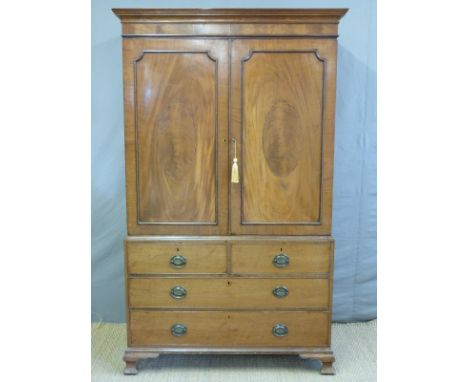 A Georgian flame mahogany linen press/housekeeper's cupboard with inlaid decoration, the base fitted two over two drawers, H2